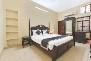 a bedroom with a large bed and shelves at Noble House - A Heritage Home in Jaipur