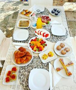 a table with plates of food on top of it at Casa Relax Isabelle in Alberobello