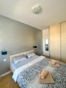 a bedroom with a large bed with two towels on it at Infinity in Banja Luka