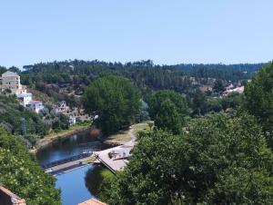 a view of a river with trees and a city at Casa Flor de Mel in Sertã