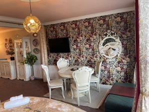 a dining room with a table and chairs at "The Italian" Seafront Apartment in Eastbourne
