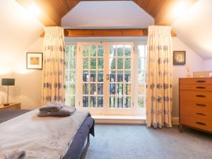 a bedroom with a bed and a large window at Pass the Keys Cosy River House With Beautiful Views in Kingston upon Thames