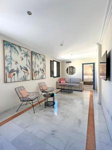 salon z krzesłami i obrazami na ścianie w obiekcie Itaca Sevilla by Soho Boutique w Sewilli