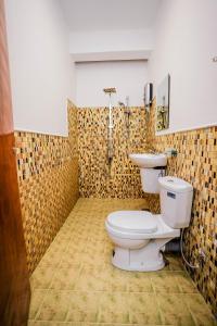 a bathroom with a toilet and a sink at River Inn - Fort in Matara