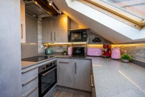 a kitchen with a sink and a stove at The Penthouse At Quayside in York