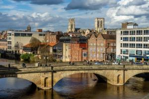 a bridge over a river in a city with buildings at The Penthouse At Quayside in York