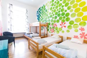 a room with two bunk beds and a mural at Old Town Hostel Alur in Tallinn