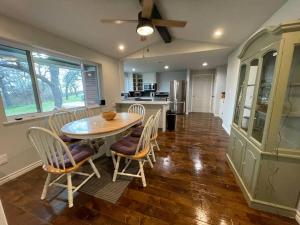 a kitchen and dining room with a table and chairs at 3BR 2BA Home at Cross Timbers in Mineral Wells