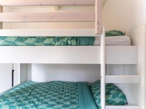 a bunk bed in a room with two bunk beds at Modern holiday home in Baarland with terrace in Baarland