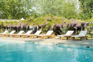 a row of lounge chairs next to a swimming pool at Camping U Casone - Maeva in Ghisonaccia