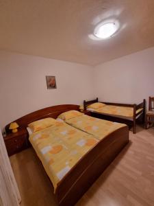 two twin beds in a room with at Apartma Rutar in Tolmin