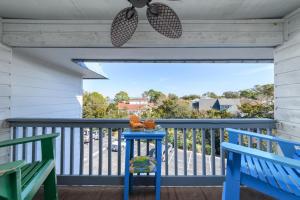 a porch with a blue table and two chairs at Love Shack in Tybee Island