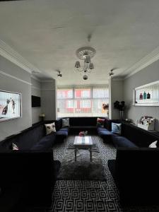 a living room with a couch and a table at Mayfair Hotel in Blackpool