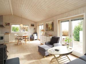 a large living room with a table and chairs at Two-Bedroom Holiday home in Stege 5 in Grevinge