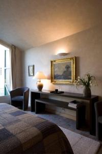 a hotel room with a desk and a bed at Château de Vierset in Vierset-Barse