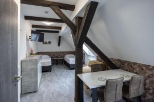 a room with a dining table and a living room at Penzion Rozhovice in Rozhovice