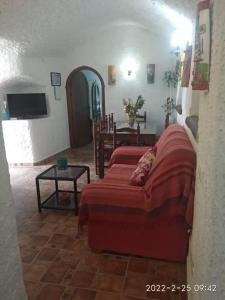 a living room with a couch and a table at CASA CUEVA VANESA in Hinojares