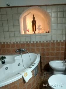 a bathroom with a tub and a sink and a toilet at CASA CUEVA VANESA in Hinojares +6 photos