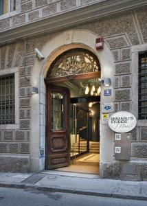 an entrance to a building with a wooden door at Urbanauts Studios Minelli in Trieste