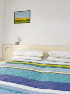 Postel nebo postele na pokoji v ubytování Hotel Rosetta