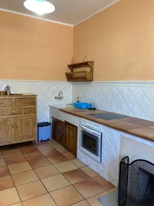 a kitchen with a sink and a stove top oven at Casa Abedul in Puebla de Lillo