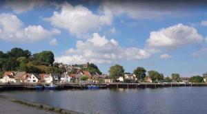 a town next to a body of water with houses at Holiday home Kamminke/Insel Usedom 3203 in Kamminke
