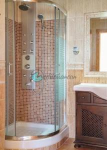 a shower in a bathroom with a sink at Ecovilla ses oliveres by villasmediterranean in Llubí