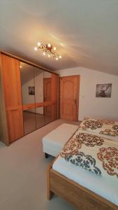 a bedroom with two beds and a mirror at Haus Bergliebe Kleinwalsertal in Riezlern