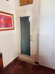a door in a room with a painting on the wall at Guest House in Campagnatico +16 photos