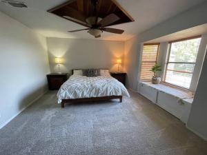 a bedroom with a bed and a ceiling fan at 4-bedroom home with gorgeous view in Mineral Wells
