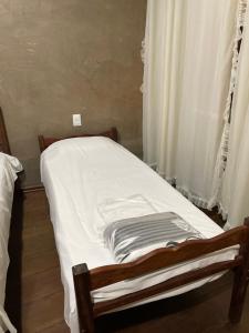 Säng eller sängar i ett rum på Pousada Gruta do Imigrante