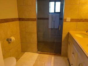 a bathroom with a shower with a toilet and a sink at 4-bedroom home with gorgeous view in Mineral Wells