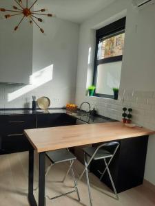 a kitchen with a wooden table and a sink at Colon 13 in Zamora
