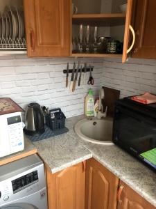 a kitchen counter with a microwave and a sink at Ahtme mnt apartaments in Ahtme