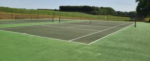 two tennis nets on a tennis court at Garden Cottage in Kelling