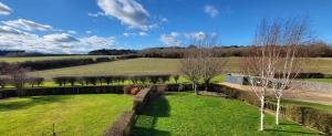 an aerial view of a field with trees and a wall at Garden Cottage in Kelling