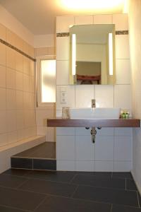 a bathroom with a sink and a mirror at Landgasthof Rebstock in Sulzburg