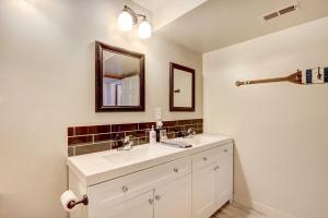 a bathroom with a white sink and a mirror at Lakefront Vacation Rental with Dock and Views! in Camdenton +22 photos