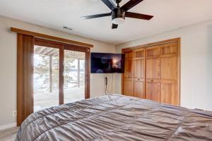 a bedroom with a bed and a ceiling fan at Lakefront Vacation Rental with Dock and Views! in Camdenton
