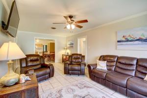 a living room with leather furniture and a ceiling fan at Coastal Long Beach Rental with Patio, Walk to Beach! in Long Beach