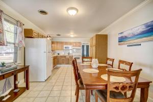 a kitchen and dining room with a table and a refrigerator at Coastal Long Beach Rental with Patio, Walk to Beach! in Long Beach