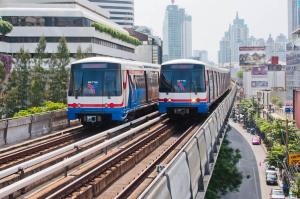 two trains are on tracks in a city at Grand Inn Hotel in Bangkok +7 photos