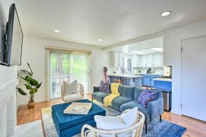 a living room with a blue couch and a kitchen at Bay Area Home Rental Near Six Flags and Napa Valley! in Vallejo