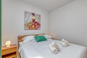 a bedroom with a white bed with towels on it at Casa Polari in Rovinj