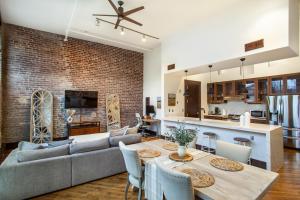 a living room and kitchen with a couch and a table at Jackson Jewel - Downtown Suite in Knoxville