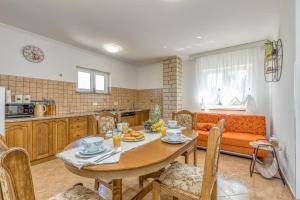 a kitchen and living room with a table and a couch at Casa Polari in Rovinj