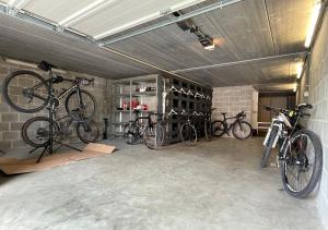 a garage with three bikes parked in it at Arcaden in Sint-Martens-Voeren