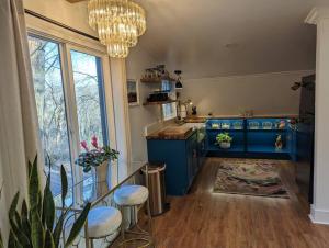 a kitchen with blue cabinets and a chandelier at Modern Cabin Close to Downtown in Nashville