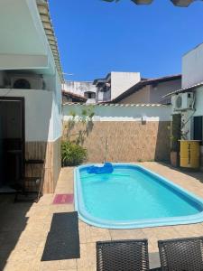 a swimming pool in the backyard of a house at Zaca’s House in Vila Velha