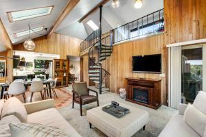 a living room with a fireplace and a staircase at The Treehouse in Bellingham